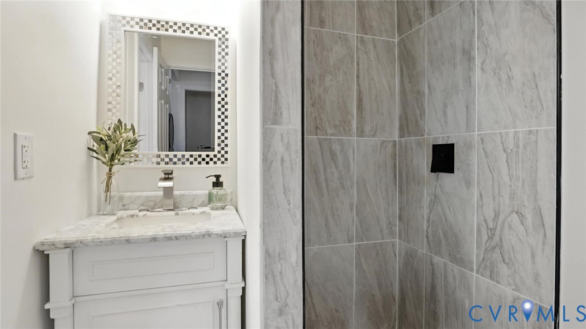 622 Grove Avenue Petersburg, VA 23803 - Photo 13 of 20 a bathroom with a granite countertop sink and a mirror