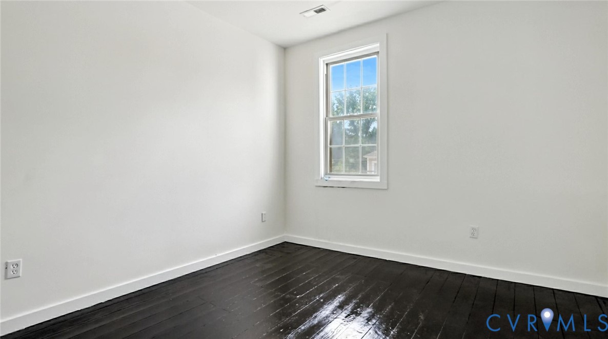 622 Grove Avenue Petersburg, VA 23803 - Photo 17 of 20 an empty room with wooden floor and windows