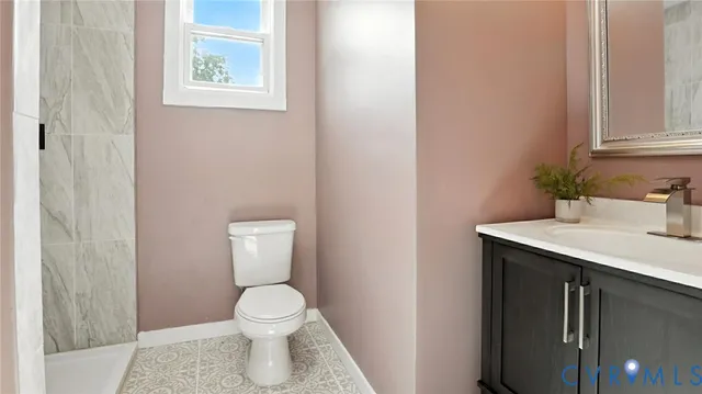 a bathroom with a sink toilet and a mirror