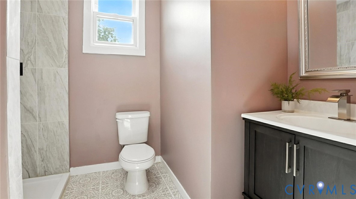 622 Grove Avenue Petersburg, VA 23803 - Photo 19 of 20 a bathroom with a sink toilet and a mirror