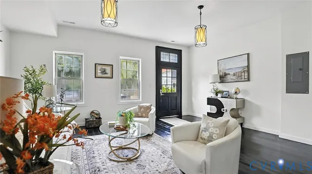 a living room with furniture a window and a chandelier