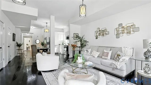 a living room with furniture and wooden floor