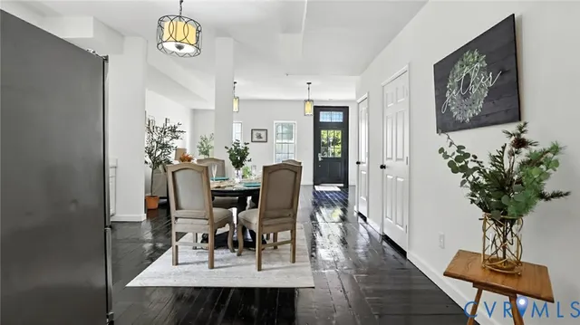 a view of a dining room with furniture and chandelier