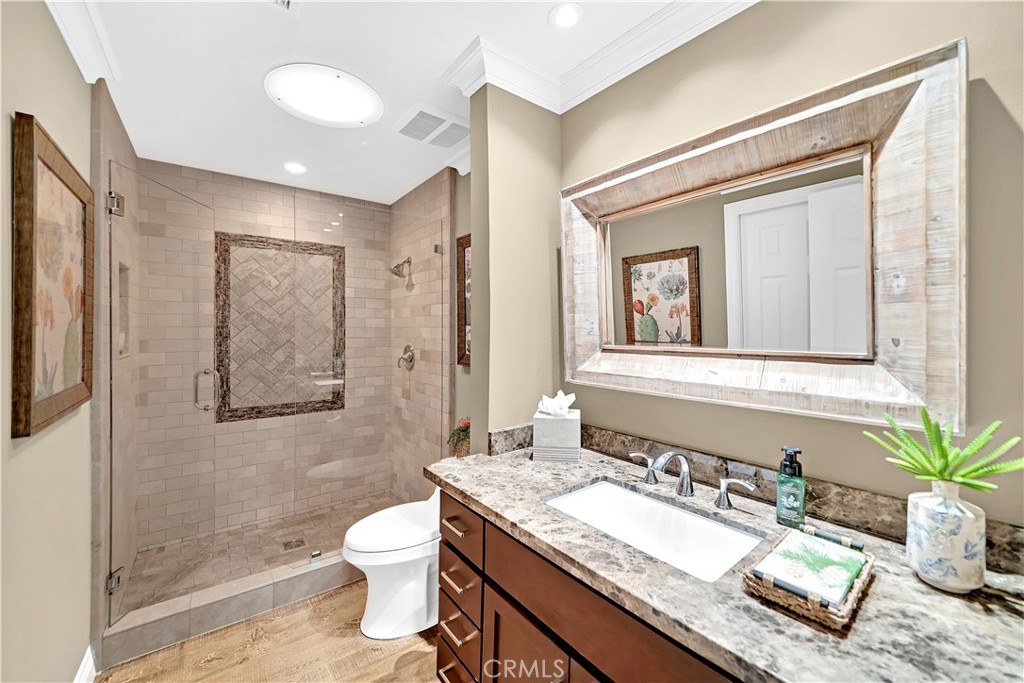 10 Crystal Pool, Unit 39 Irvine, CA 92603 - Photo 20 of 30 a bathroom with a granite countertop sink toilet a mirror and shower