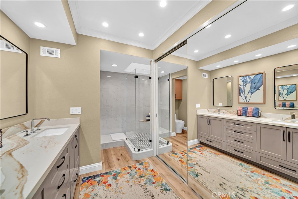 10 Crystal Pool, Unit 39 Irvine, CA 92603 - Photo 26 of 30 a bathroom with a double vanity sink a mirror and a bathtub