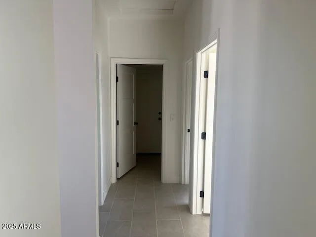 a view of a hallway with an entryway door