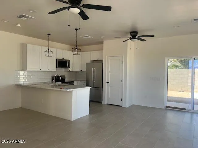a kitchen with stainless steel appliances a refrigerator sink and microwave