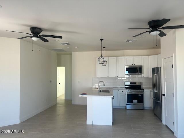 15988 South Yava Road Arizona City, AZ 85123 - Photo 7 of 21 a kitchen with kitchen island white cabinets and stainless steel appliances