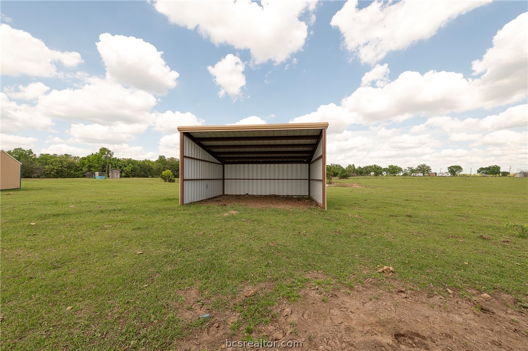 10976 Whiterock Road Bremond, TX 76629 - Photo 34 of 42 a backyard of a house with lots of green space and lake view