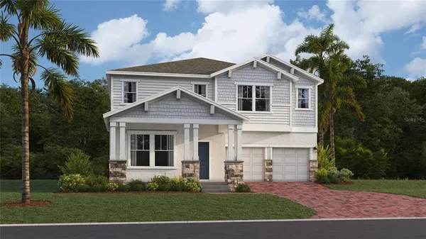 a front view of a house with a yard and trees