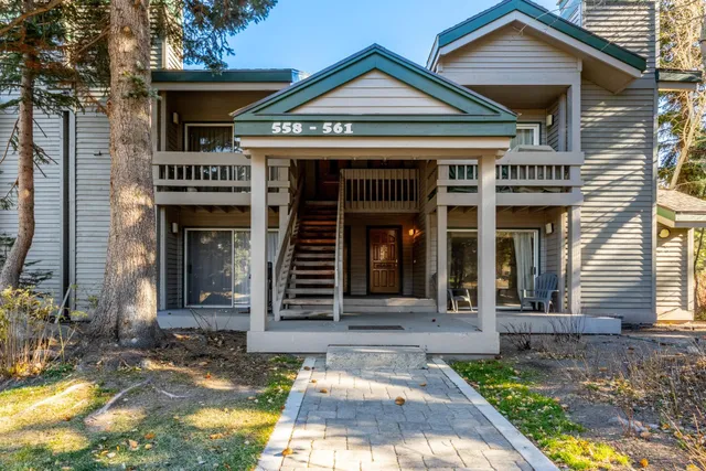 a view of a brick house with potted plants