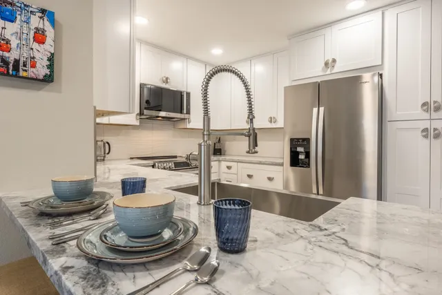 a kitchen with a stove and a refrigerator
