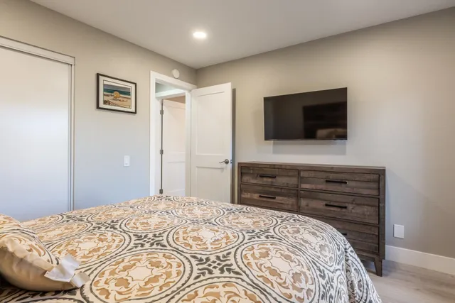 a bedroom with a bed and a flat screen tv