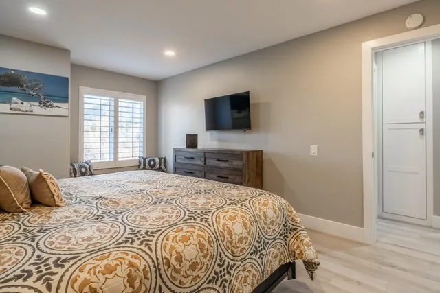 a bedroom with a bed and a flat screen tv