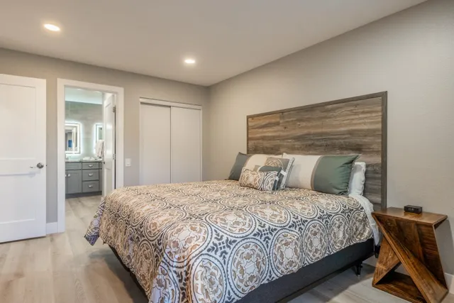 a bedroom with a bed and glass door
