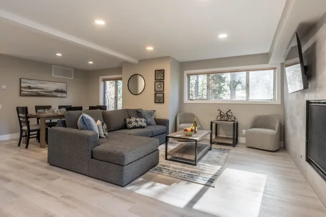 a living room with furniture window and flat screen tv
