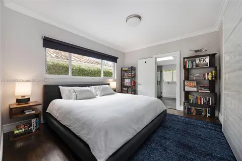 a bedroom with a large bed and a large window