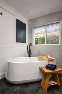 a white bath tub sitting in a bathroom