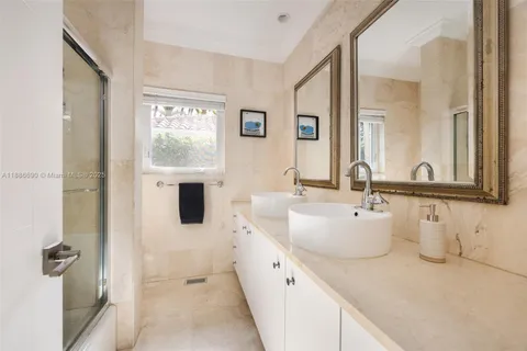 a spacious bathroom with a tub sink and mirror