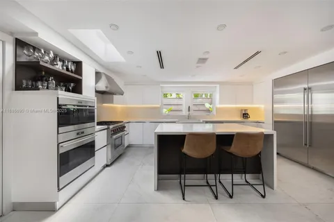 a kitchen with granite countertop a counter space stainless steel appliances and cabinets