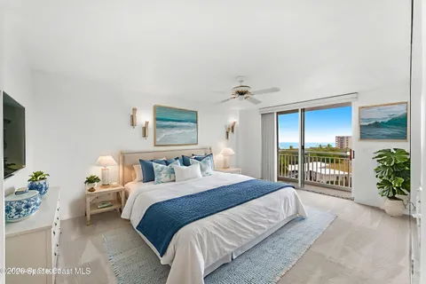 a bedroom with a balcony a bed and a couch