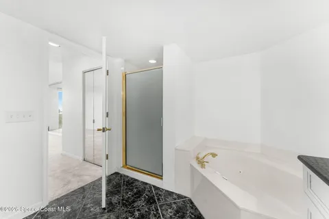 a bathroom with a tub a sink and shower