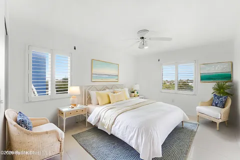 a spacious bedroom with a bed and couch