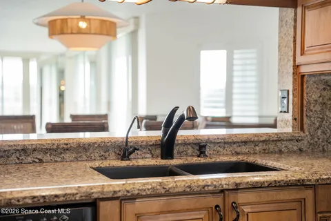 a kitchen with granite countertop a sink and a window