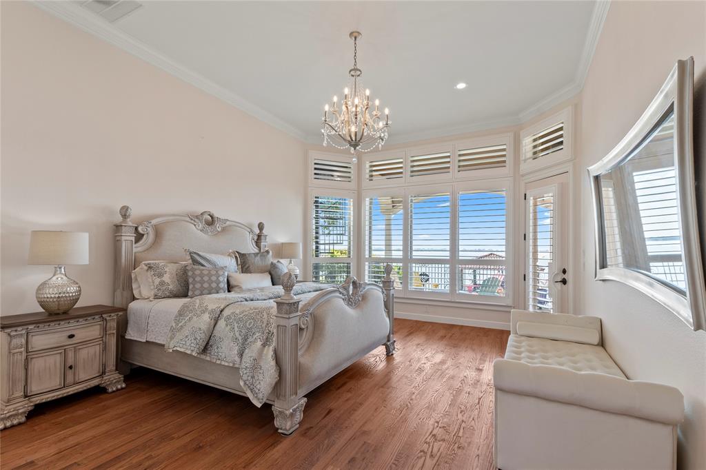 204 Pinnacle Club Place Mabank, TX 75156 - Photo 15 of 40 Waterside Primary suite featuring wood floors, wall of windows with plantation shutters.