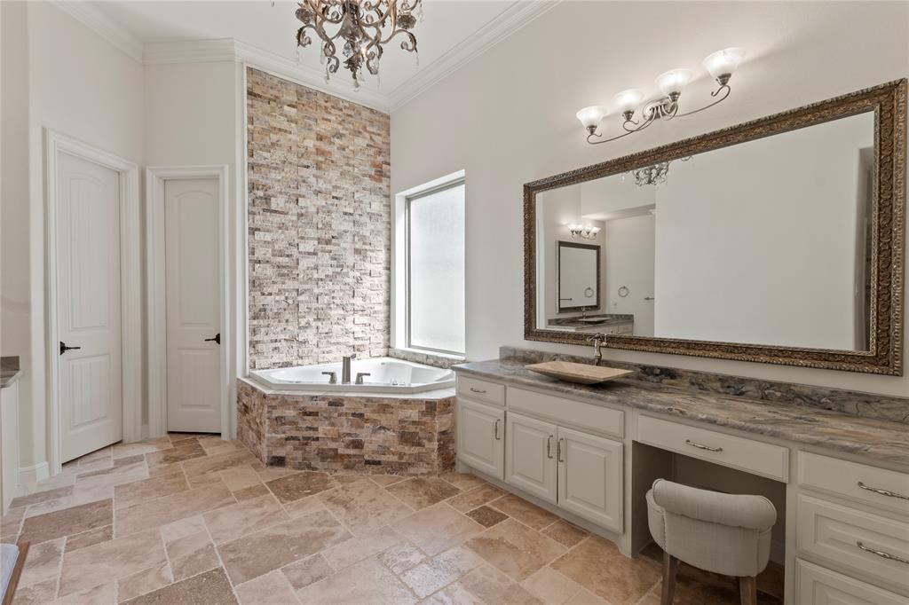 204 Pinnacle Club Place Mabank, TX 75156 - Photo 16 of 40 Spa-like ensuite with dual vanities, stacked-stone soaking tub, spacious tiled shower and two walk-in closets.