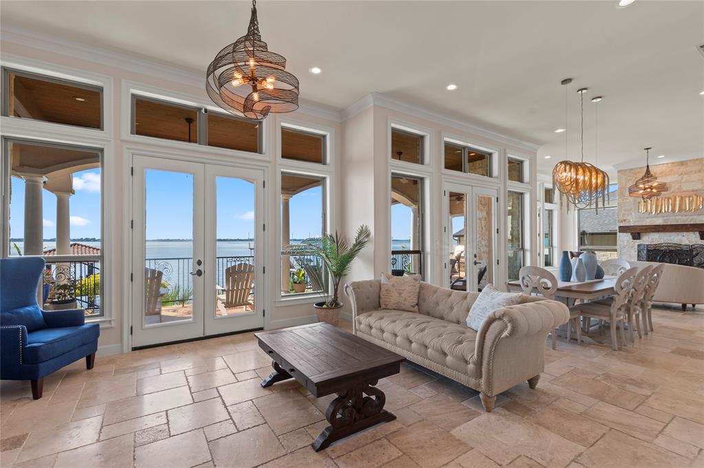 204 Pinnacle Club Place Mabank, TX 75156 - Photo 6 of 40 Expansive windows frame open-water views across two living areas with a spacious dining area and butlers pantry