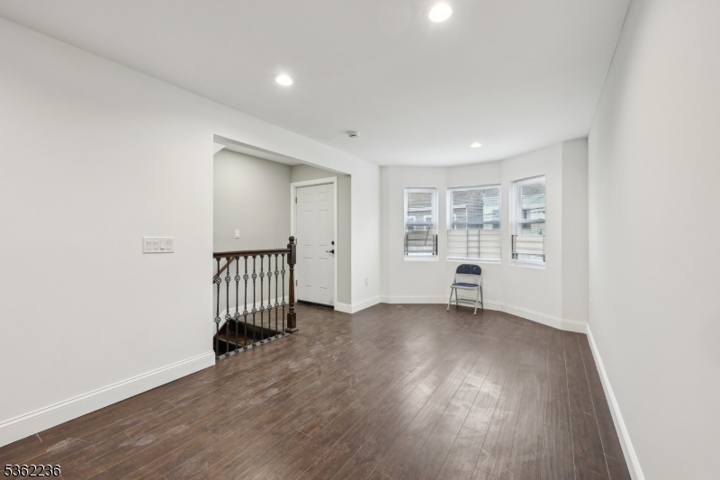 253 North 4th Street Paterson, NJ 07522 - Photo 3 of 15 an empty room with wooden floor and a window