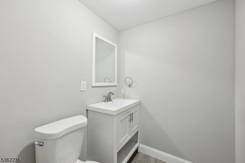 253 North 4th Street Paterson, NJ 07522 - Photo 4 of 15 a bathroom with a sink a toilet and mirror