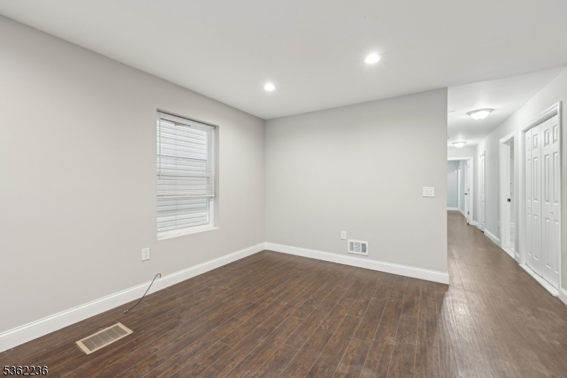 253 North 4th Street Paterson, NJ 07522 - Photo 5 of 15 wooden floor in an empty room with a window
