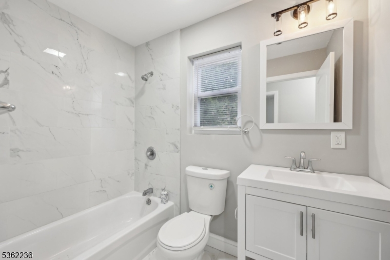 253 North 4th Street Paterson, NJ 07522 - Photo 6 of 15 a bathroom with a sink toilet and shower
