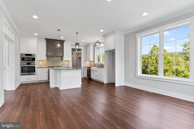 a open kitchen with granite countertop a sink and dishwasher with wooden floor