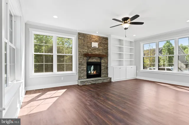 a view of livingroom with furniture wooden floor and windows