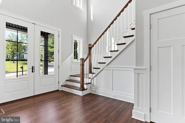 a view of entryway and hall with wooden floor