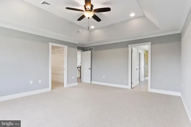 a spacious bathroom with a double vanity sink a large mirror and a bathtub