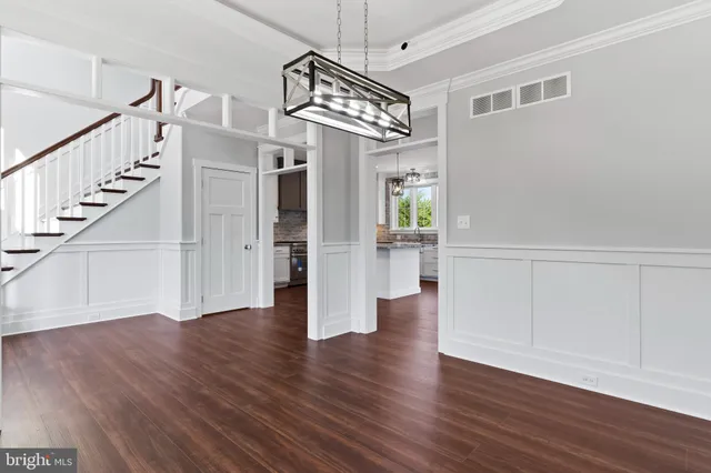 a view of a room with wooden floor and windows