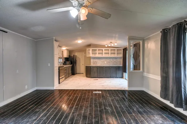 a view of kitchen with sink and refrigerator
