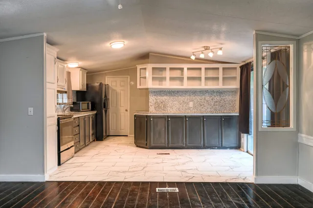 a kitchen with a refrigerator and a sink