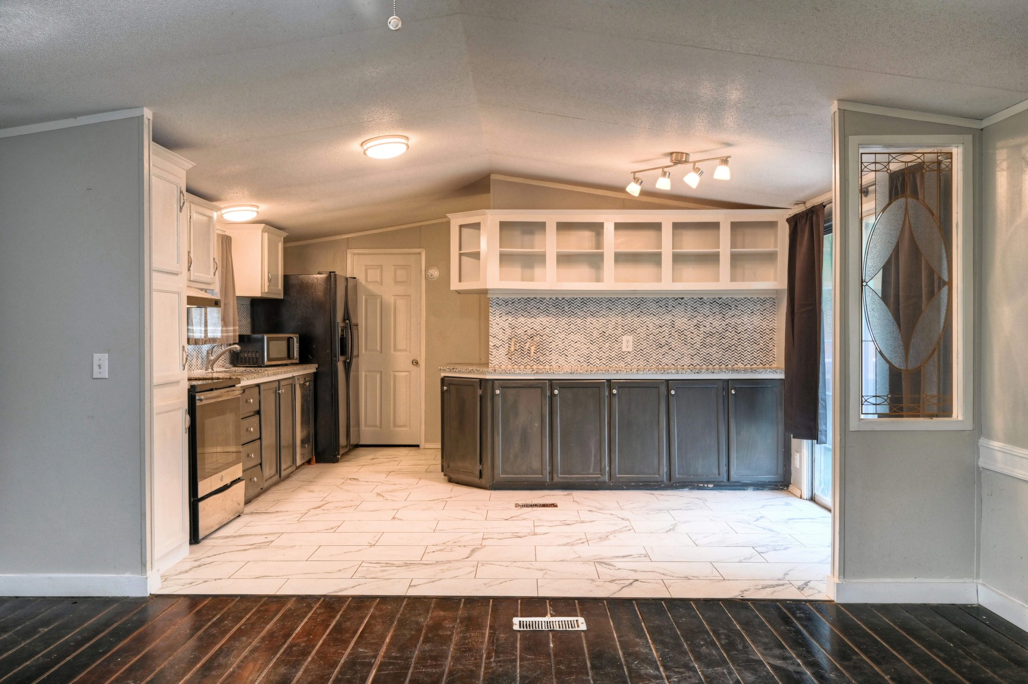 13204 Enchanted Vista Willis, TX 77318 - Photo 13 of 43 a kitchen with a refrigerator and a sink