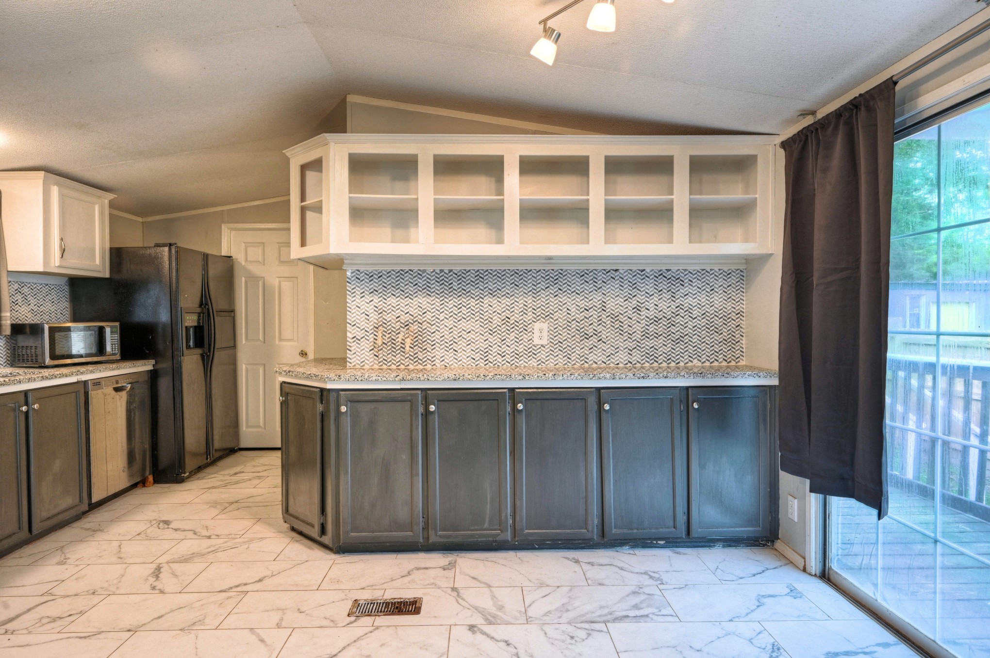 13204 Enchanted Vista Willis, TX 77318 - Photo 14 of 43 a kitchen with stainless steel appliances granite countertop a refrigerator and a sink