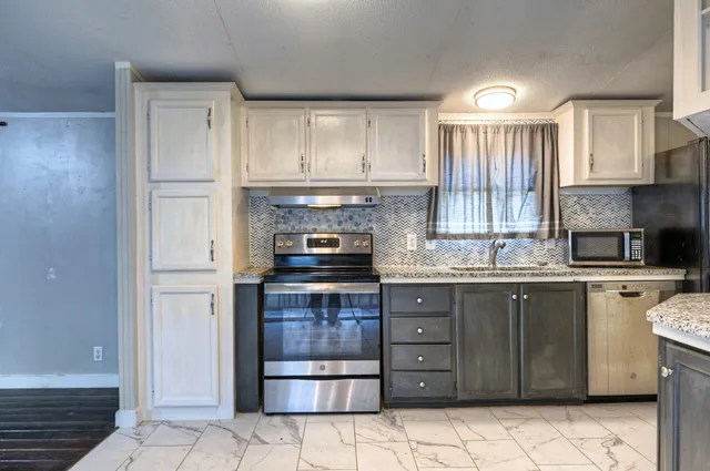 a kitchen with a refrigerator sink and cabinets