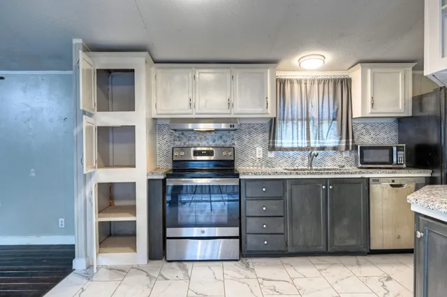 a kitchen with a stove top oven and sink