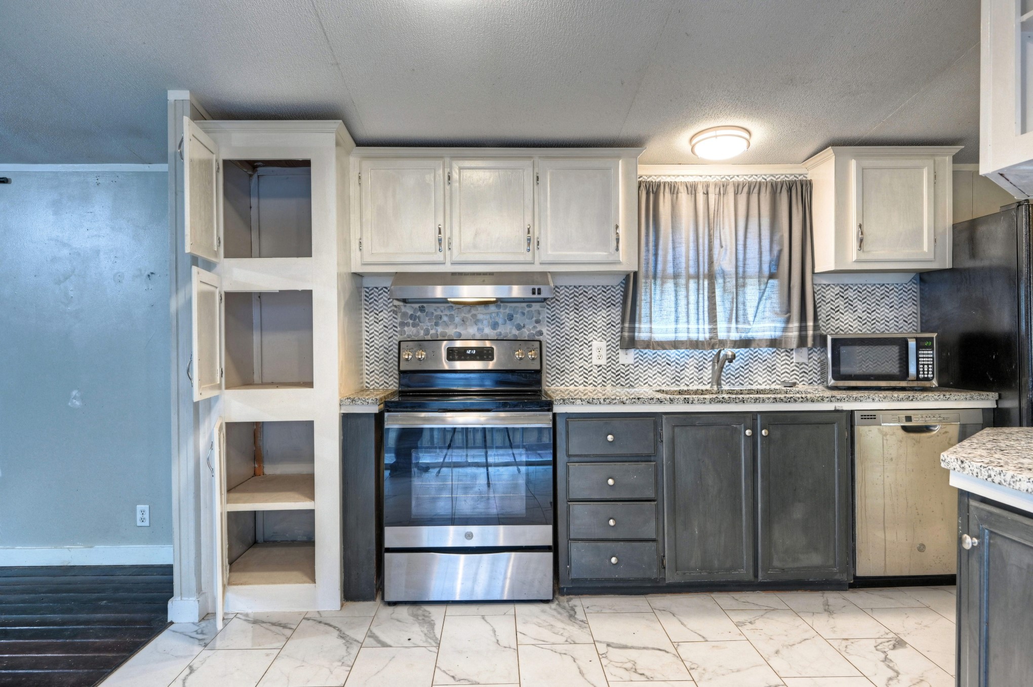 13204 Enchanted Vista Willis, TX 77318 - Photo 16 of 43 a kitchen with a stove top oven and sink