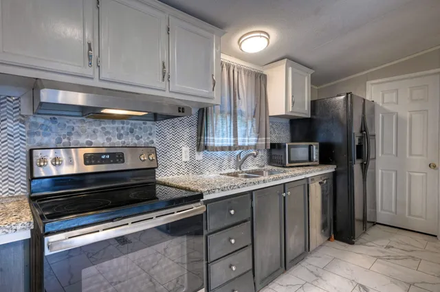 a kitchen with appliances cabinets and a counter top space