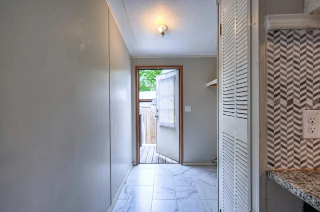 a view of a hallway to rooms