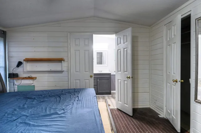 a view of a hallway to a bedroom and wooden floor